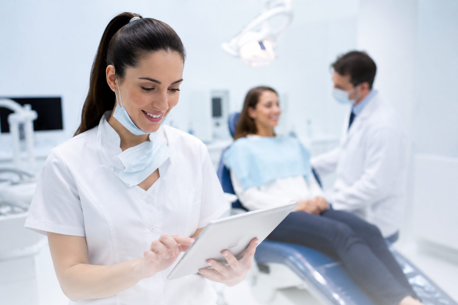 A dental specialist focused on patient care in a modern operatory.